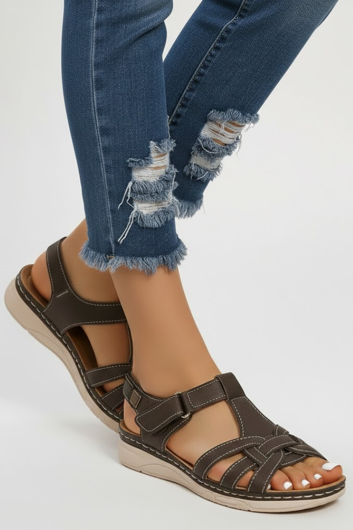 Pair of women's retro flat sandals with adjustable buckle straps, perfect for warm weather casual wear.