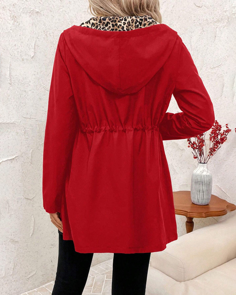Stylish women's reversible hooded coat featuring bold leopard print design, fall fashion