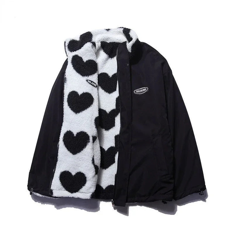 Close-up of heart quilting on women's reversible jacket, black fabric texture, winter coat detail