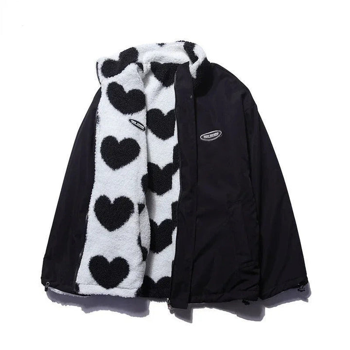 Close-up of heart quilting on women's reversible jacket, black fabric texture, winter coat detail