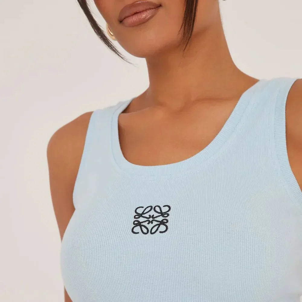 Modern casual chic women's sleeveless top, ripped design, and elegant embroidery detail.