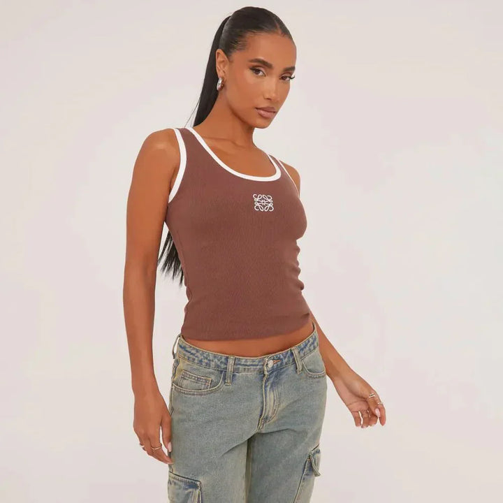 Full product shot: Women's ripped tank top, showcasing delicate embroidery and sleeveless design.
