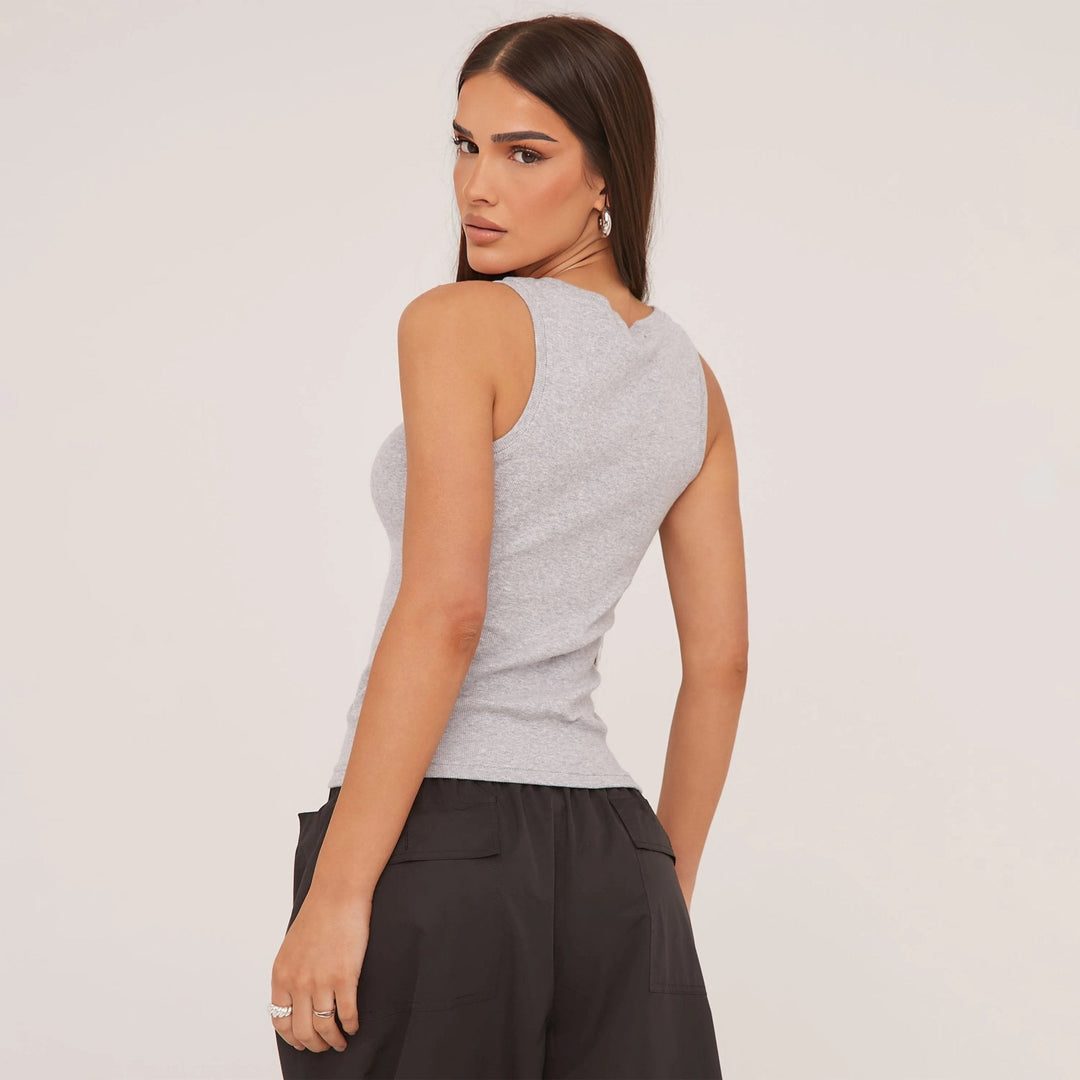 Fashionable women's sleeveless top, ripped design & elegant embroidery. Versatile daily wear.
