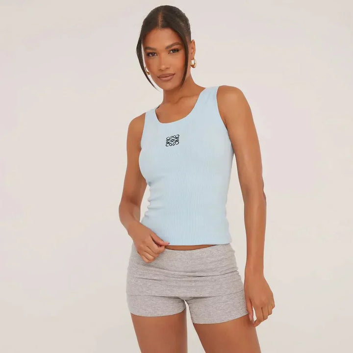 Women's elegant ripped tank top, delicate embroidery detail. Perfect for fashionable summer style.