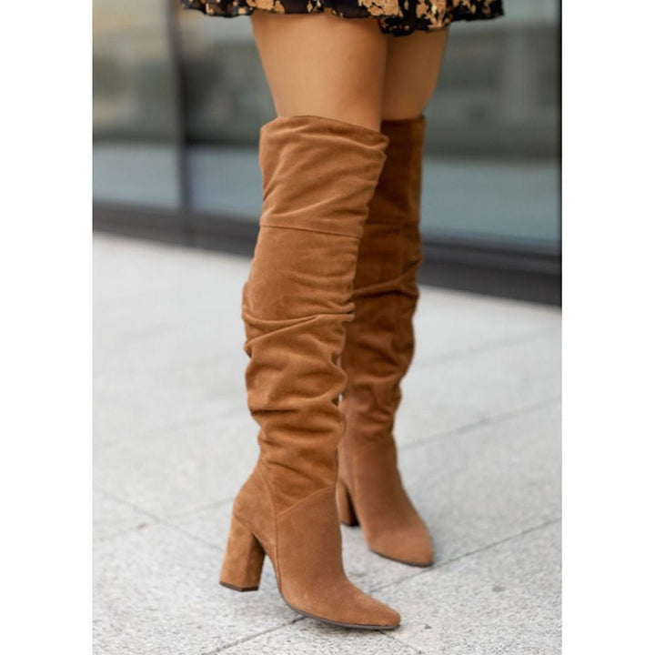 Chic women's ruched over-the-knee boots with a practical block heel, a versatile winter boot.
