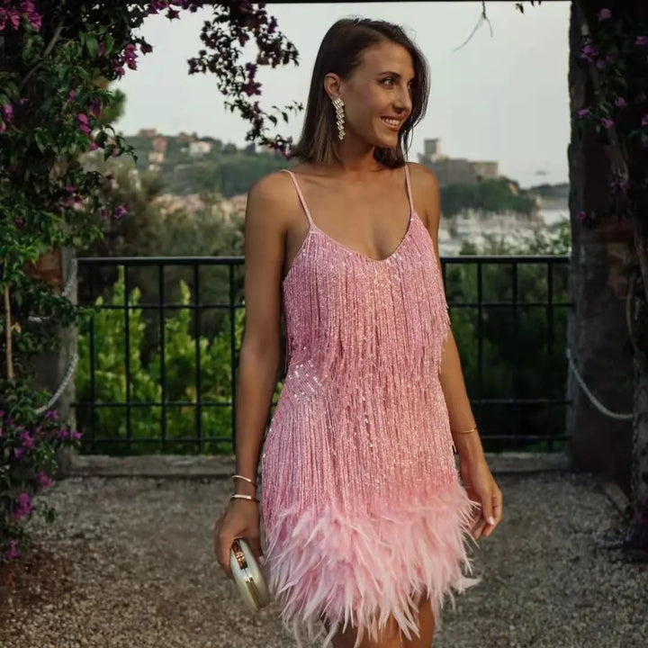 Elegant women's evening wear: a sequin and fringe cocktail dress designed with feather embellishments.