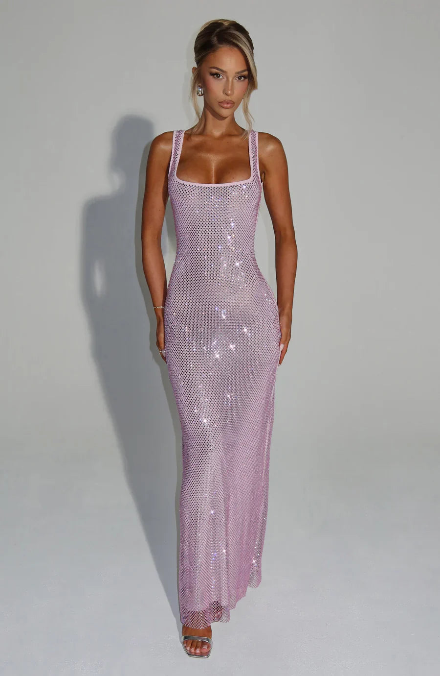 Sophisticated women's wedding guest dress, shimmering embellished long style.