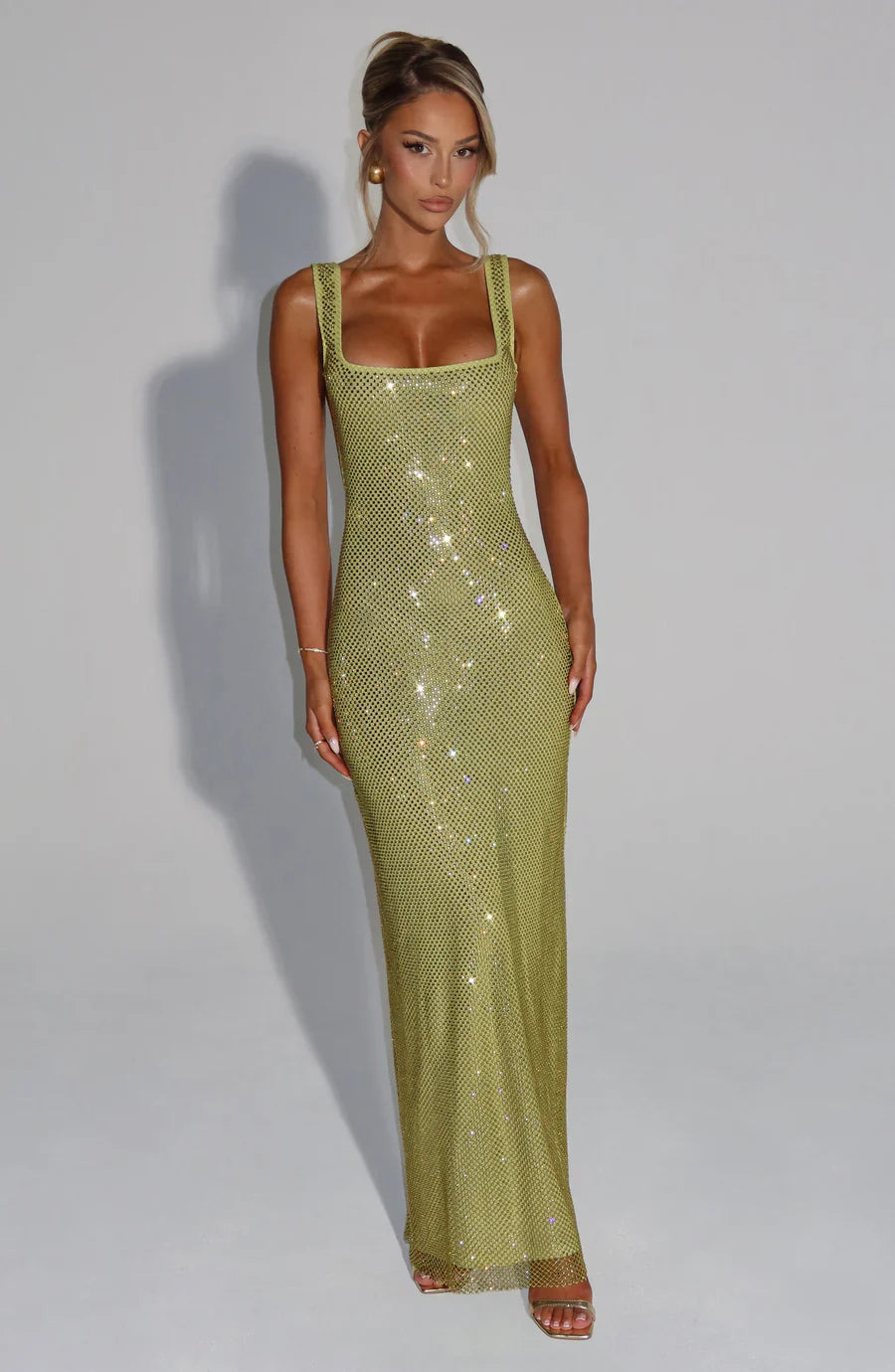 Luxurious embellished maxi dress, shimmering and elegant for women's special occasions.