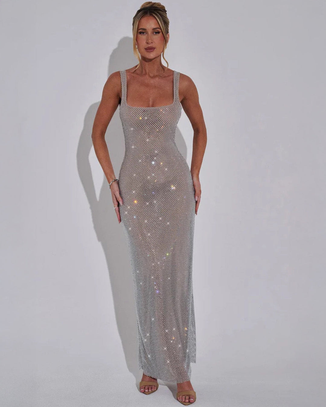 Sophisticated wedding guest dress, a shimmering embellished maxi gown.