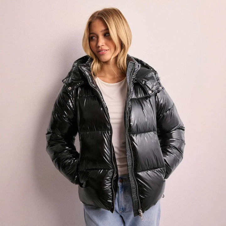 Women's shiny quilted jacket with removable hood, ideal warm winter outerwear for stylish ladies.