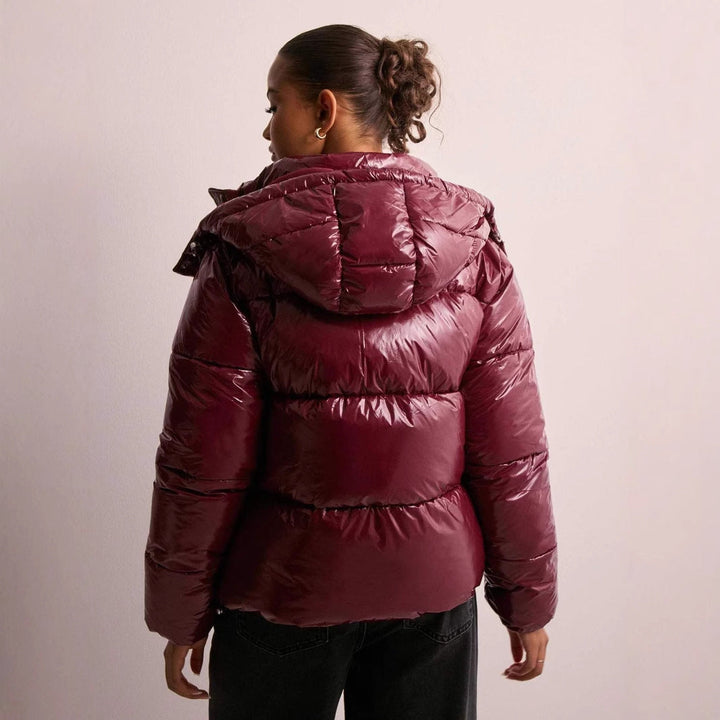 Versatile women's shiny quilted jacket, warm winter coat with removable hood, perfect for cold weather.