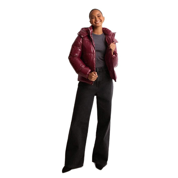Elegant women's shiny quilted winter jacket, warm and stylish outerwear with a convenient removable hood.