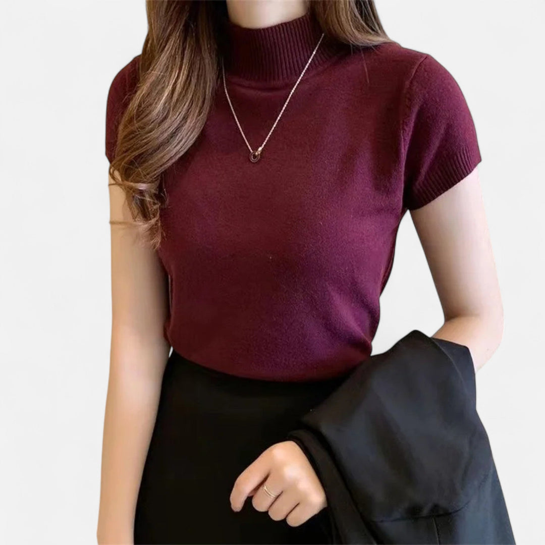 Soft women's short-sleeve turtleneck blouse, an elegant top that combines comfort with sophisticated style.