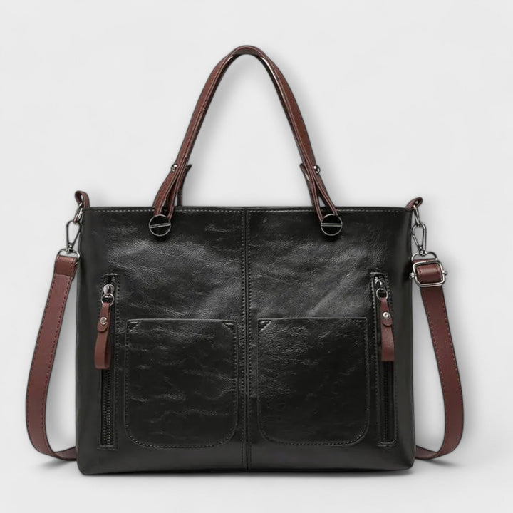 Detail shot of the comfortable wide strap on the women's functional everyday shoulder bag, black color.