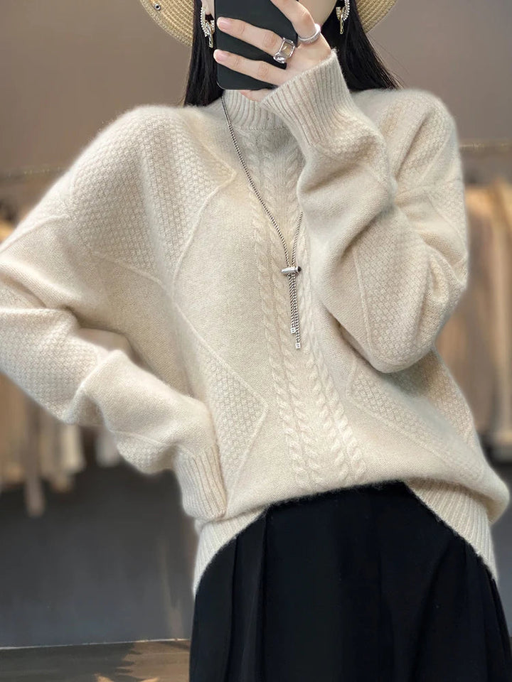 Close-up of luxurious women's cashmere roll neck jumper, showcasing the intricate cable knit texture.