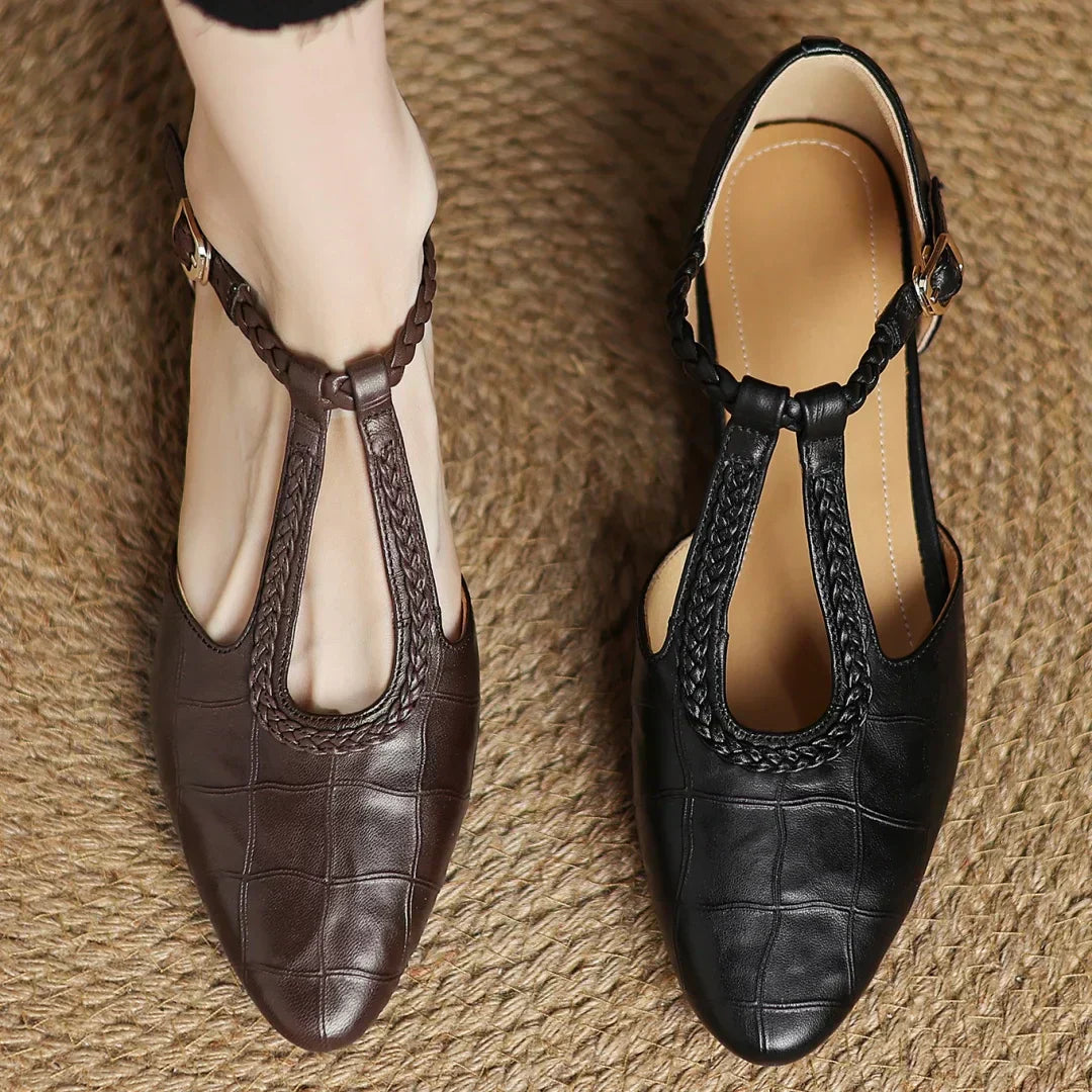 Side view of a women's comfortable soft leather T-strap Mary Jane shoe with a subtle low heel