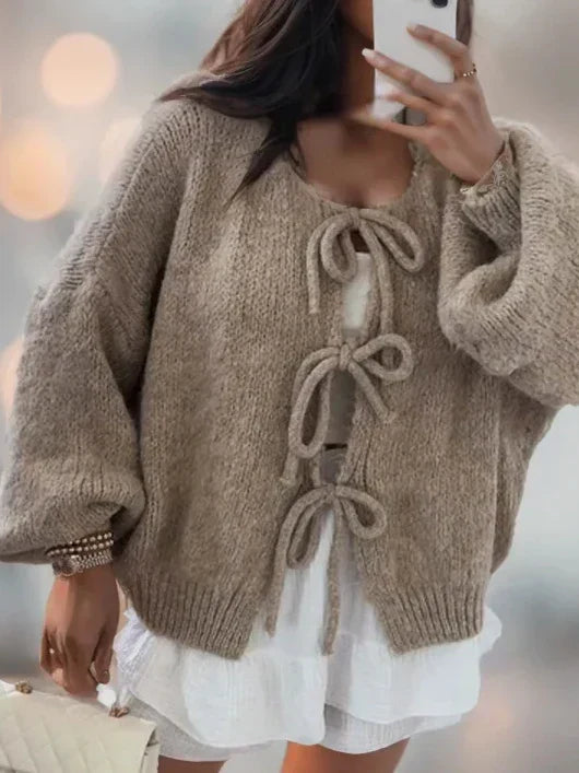 Lightweight knit women's cardigan with chic bow ties, perfect for elegant and stylish layering.