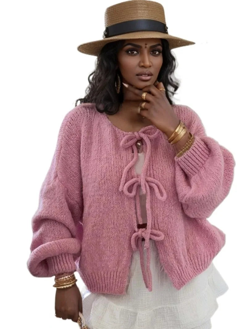 Stylish layering: women's soft knit cardigan featuring elegant bow ties, a versatile sweater.
