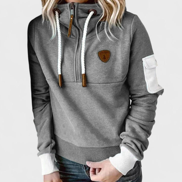 Model wearing a women's comfortable soft knit jumper with an open zip neckline, relaxed fit
