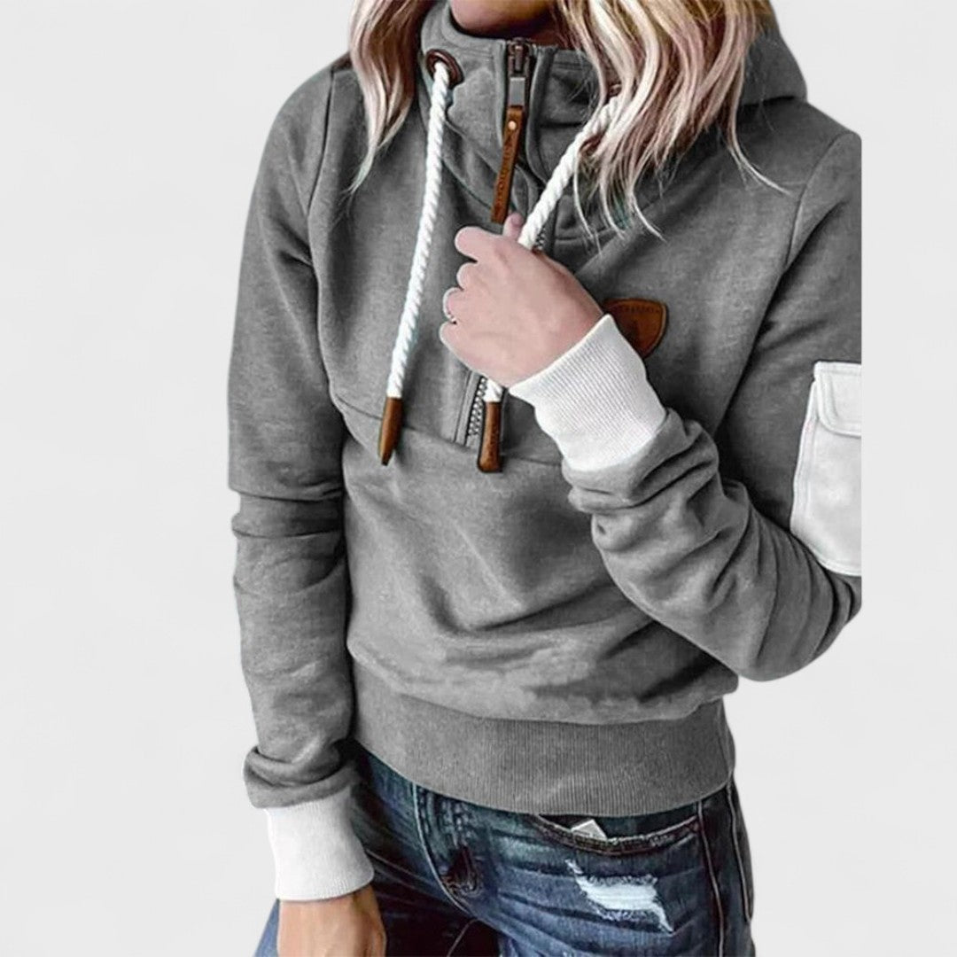 Detail of the ribbed cuffs and hem on a women's soft knit zip neck jumper, autumn essential