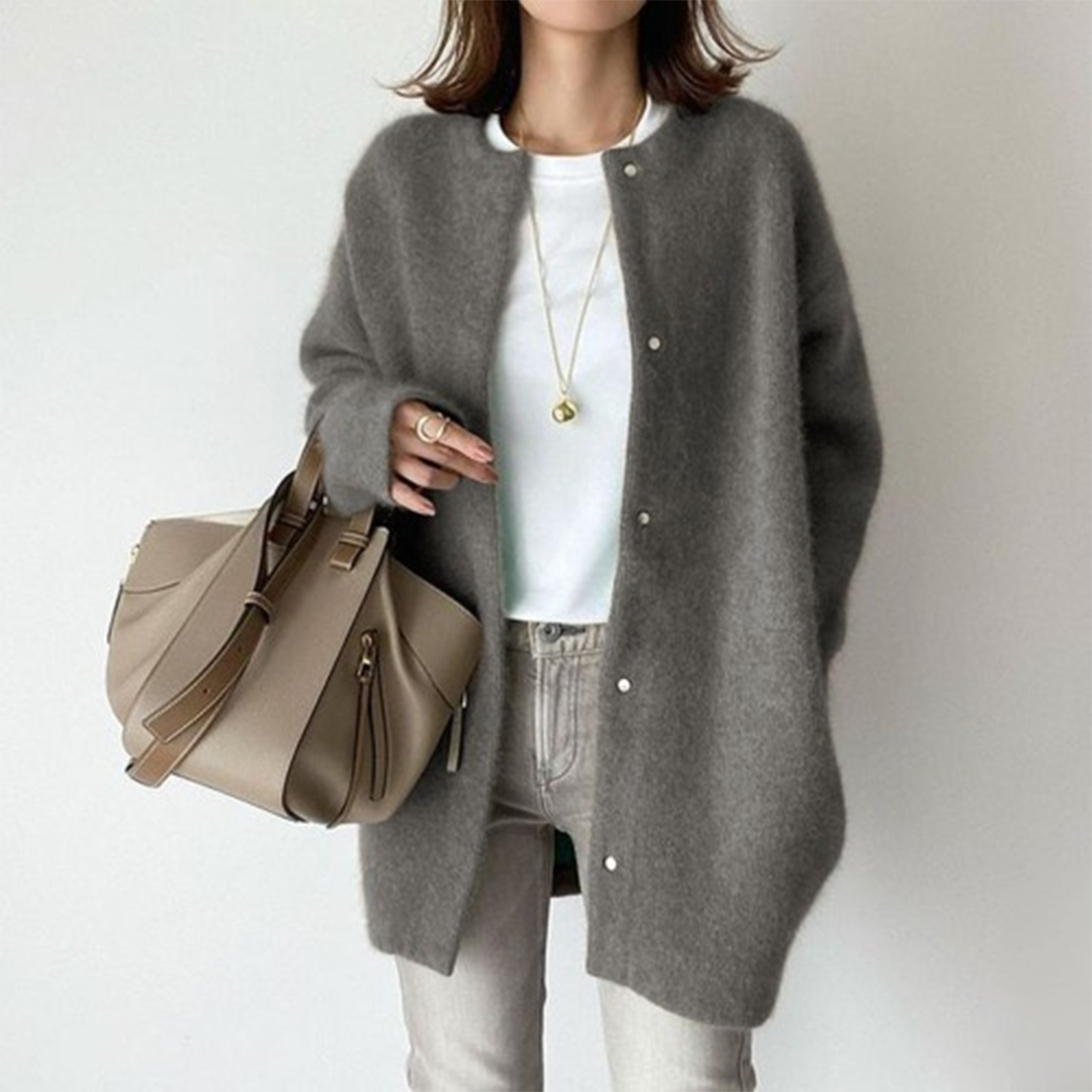 Close-up of the soft knit texture of a women's relaxed fit long cardigan, emphasizing comfort.