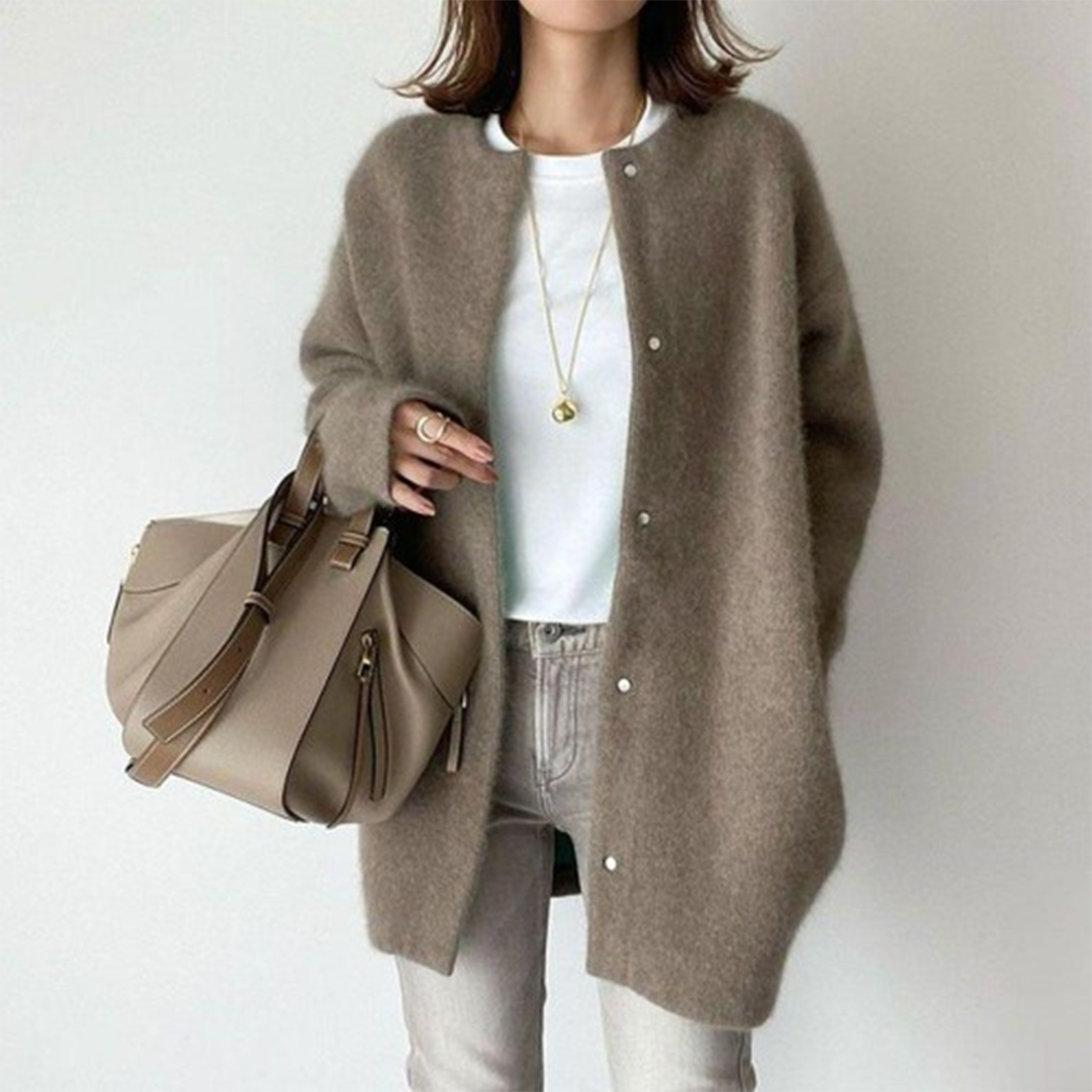 Stylish women's long sweater in a relaxed fit, featuring buttons, suitable for fall fashion.