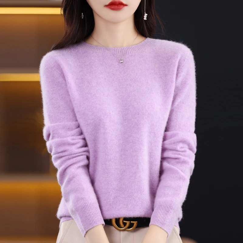 Detail shot of soft knit texture on women's warm luxury round neck sweater. Elegant winter wear.
