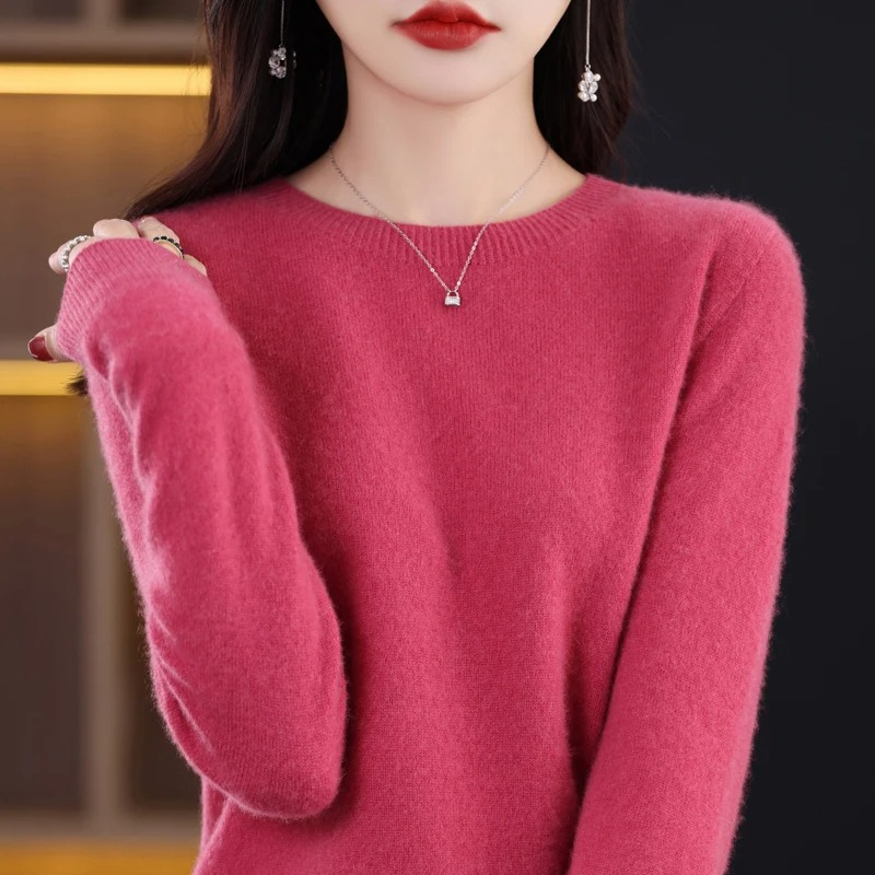 Model wearing women's chic round neck luxury knit sweater. Warm long sleeve for stylish winter fashion.