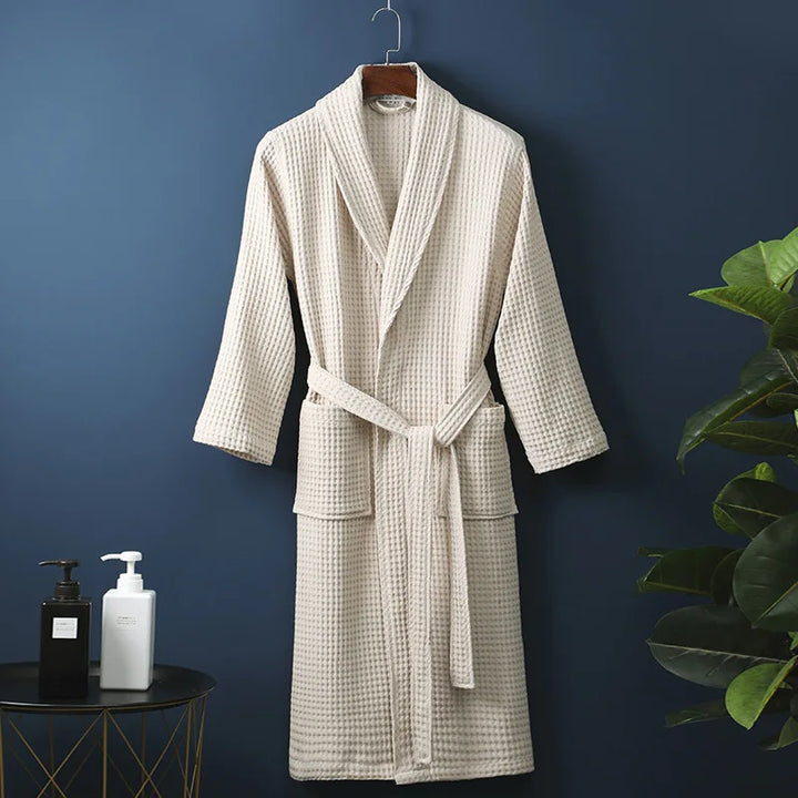 Woman relaxing in a comfy spring waffle lounge robe, showcasing its comfort and home wear appeal.