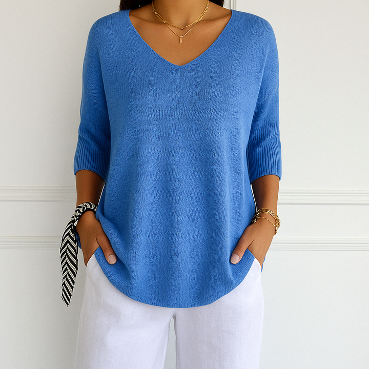 Side profile of women wearing a v-neck short sleeve lightweight sweater, relaxed fit