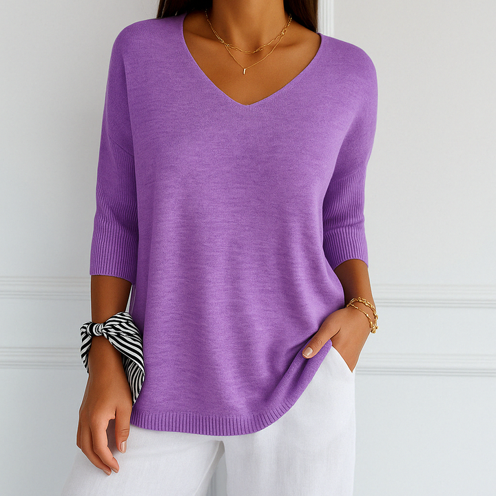 Close-up of the knit texture on a women's v-neck short sleeve lightweight sweater