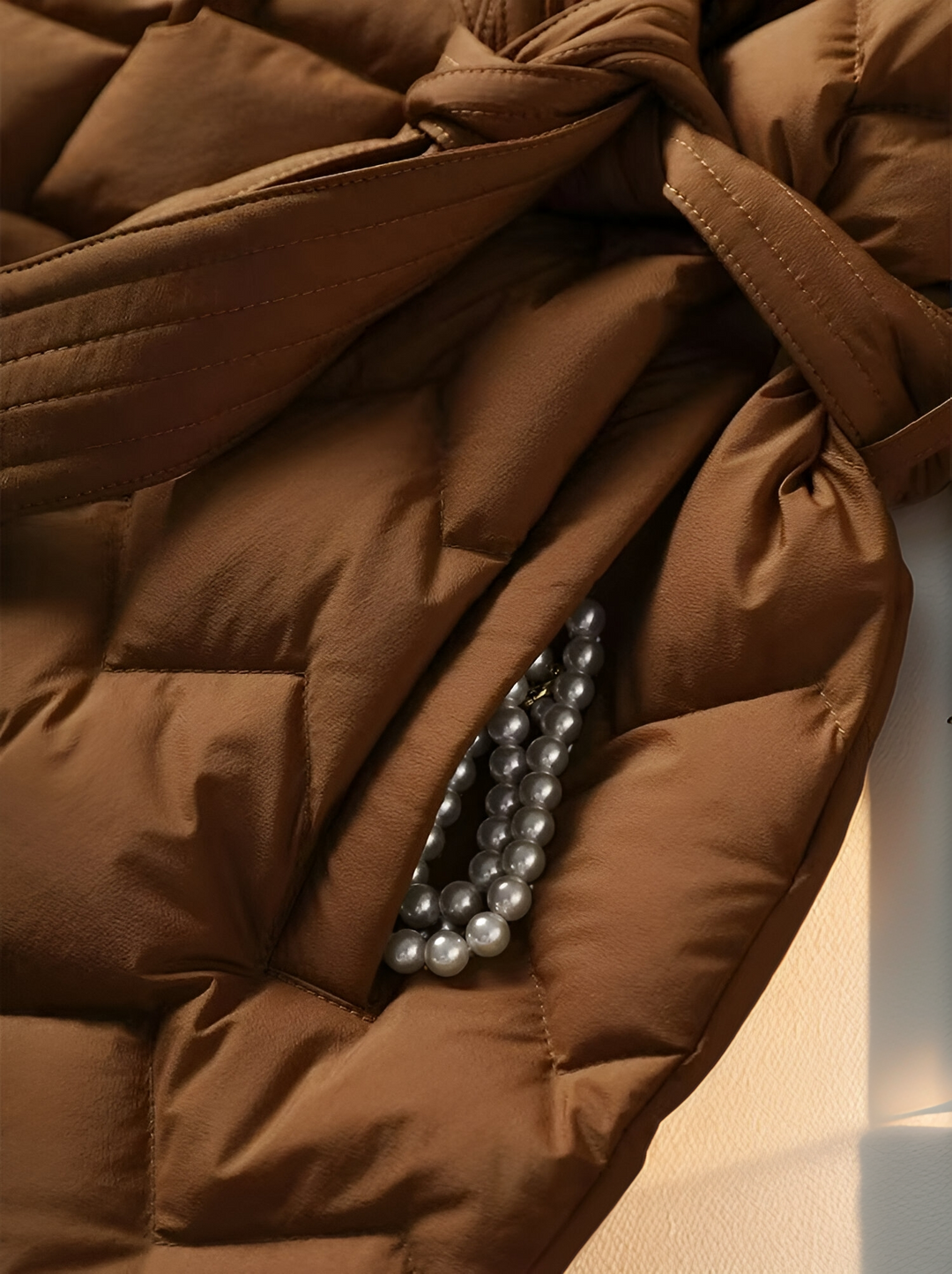 Chic women's Sophie padded winter coat, elegant belted style for cold weather fashion.