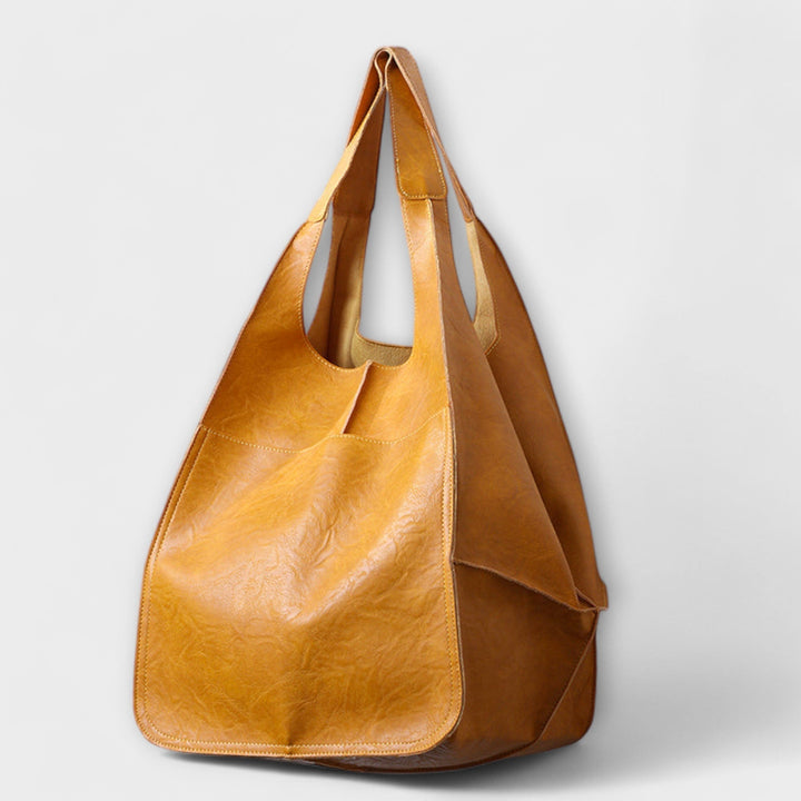 Everyday women's bag from a side angle, highlighting its classic silhouette and generous depth.