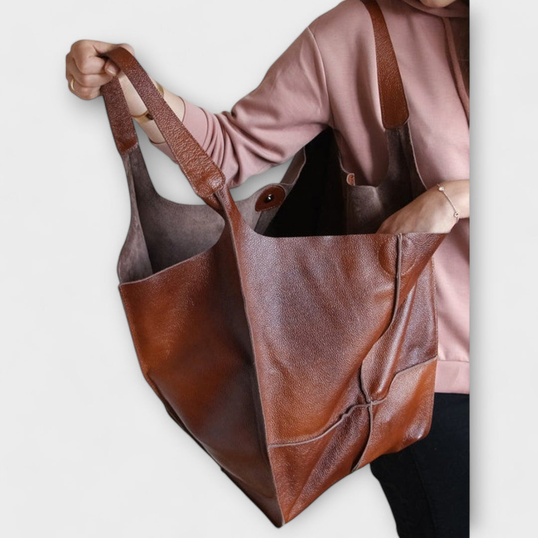 Women's everyday bag shown open, revealing its generous capacity, great for organization.