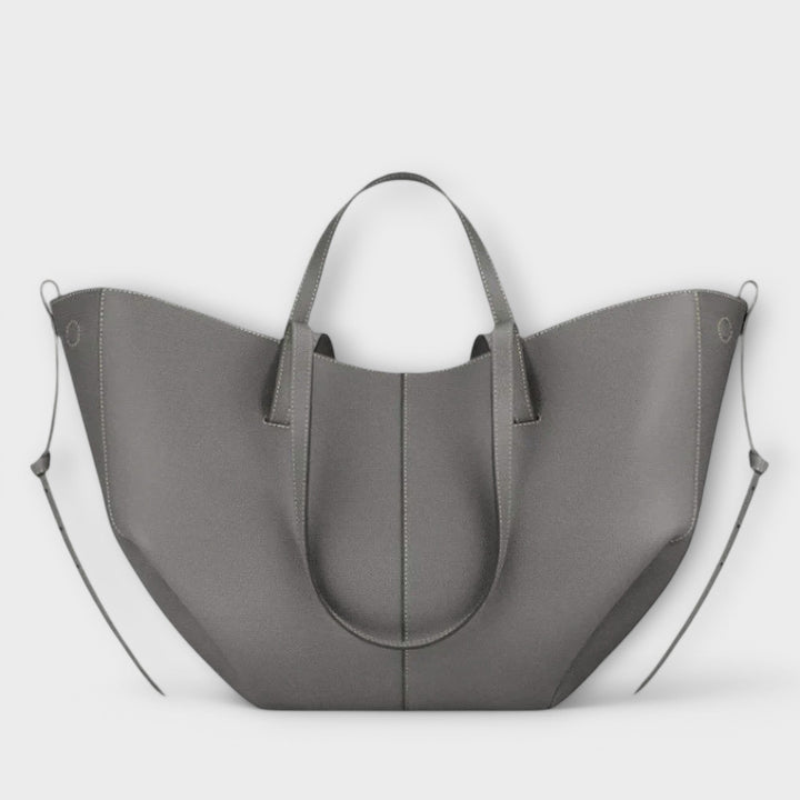 Women's casual tote bag displayed on a clean background, emphasizing its size and classic look.