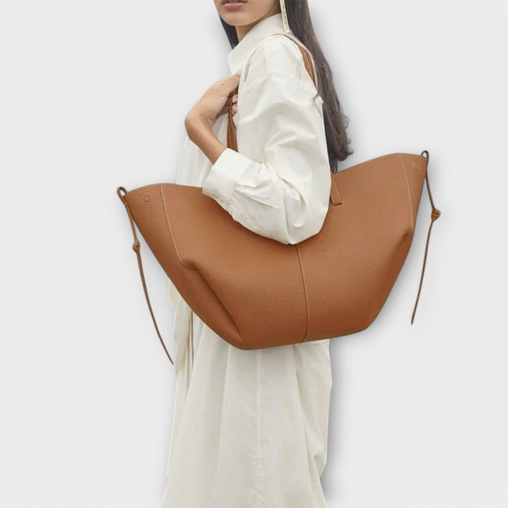 Faux leather spacious tote bag for women, ideal for daily essentials or as a travel carry-on.