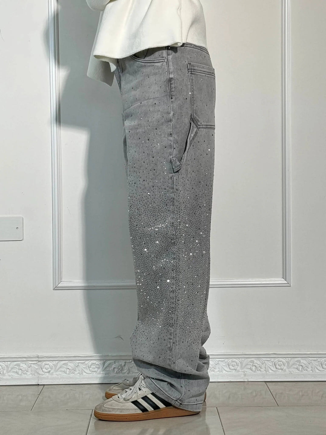 Flat lay of women's trendy sparkle high-waist straight-leg jeans with stylish accessories. Fashionable.