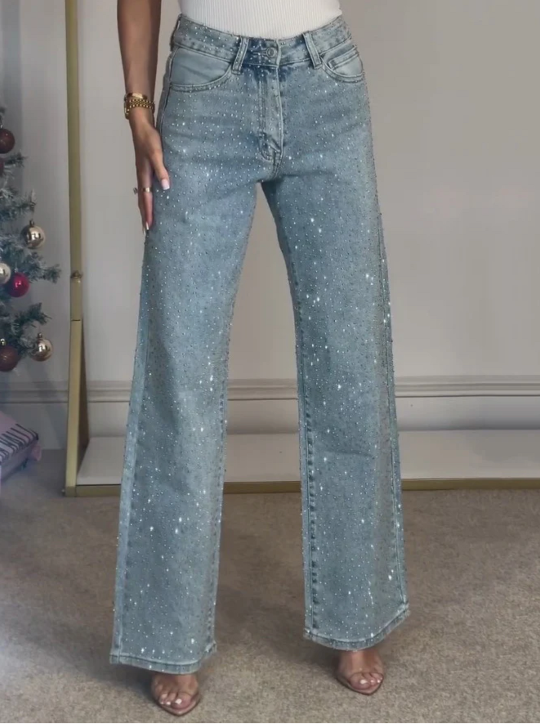 Side profile of model in women's high-waist sparkle straight-leg jeans, showing structured fit & chic look.