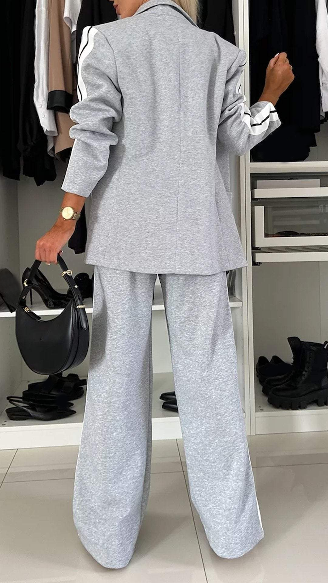 Stylish women's sporty chic two-piece suit with a modern blazer & elegant striped trousers for diverse occasions.