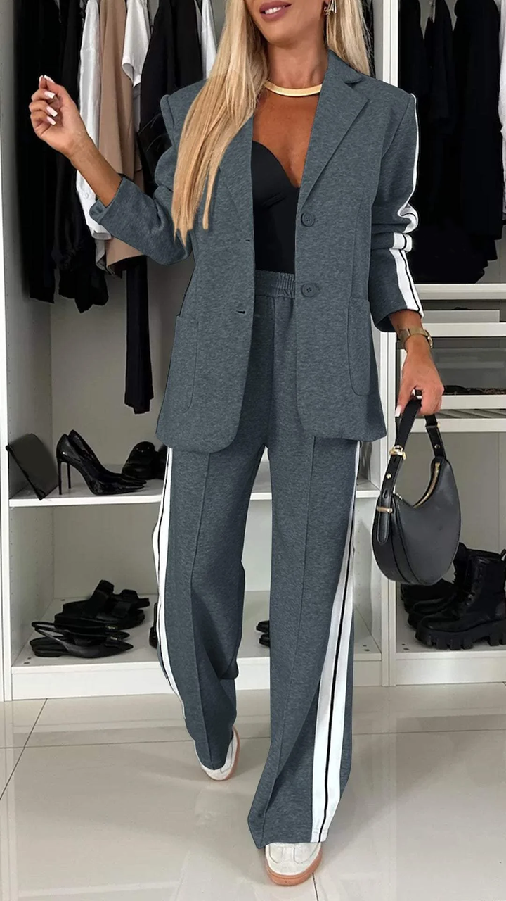 Modern women's two-piece suit: chic oversized blazer & comfortable striped trousers for urban style.