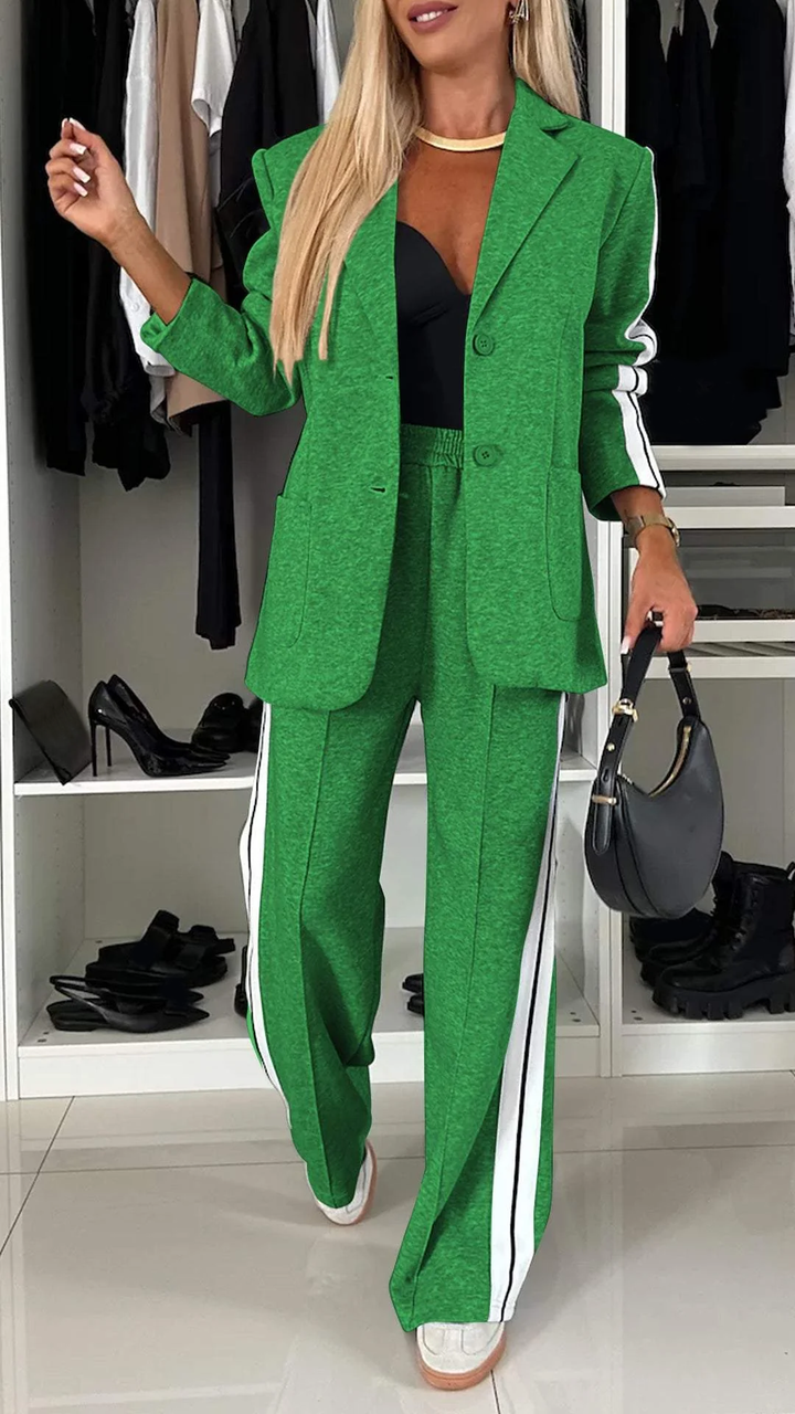 Oversized women's blazer & striped trousers in a sporty chic two-piece suit for a contemporary, comfortable style.