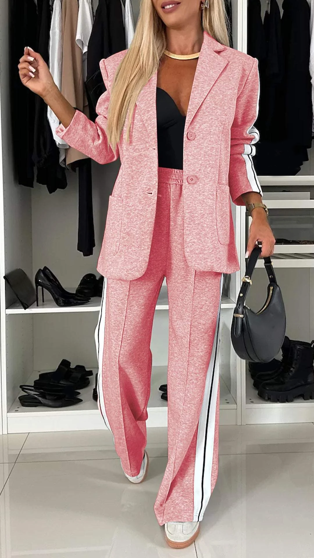 Chic women's oversized blazer paired with striped trousers, creating a sporty two-piece suit for daily wear.