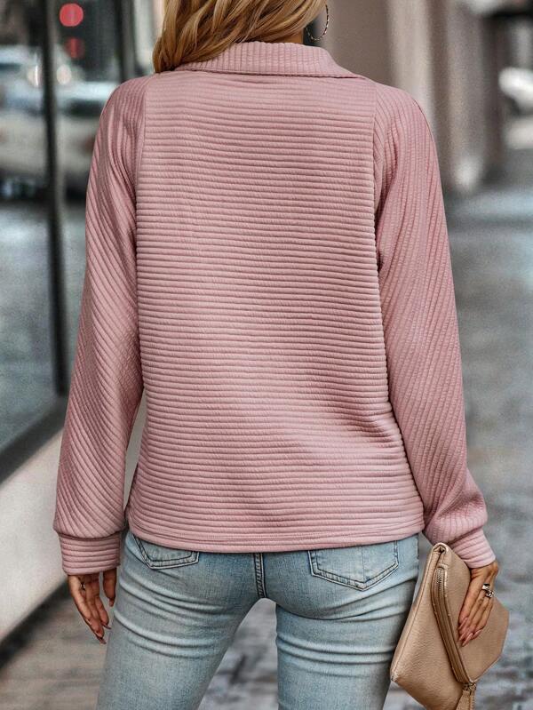 Back view of a women's casual knit half-zip pullover, emphasizing its relaxed fit for spring