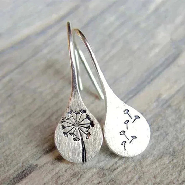 Women's sterling silver dandelion teardrop dangle earrings. Elegant nature-inspired hook earrings.