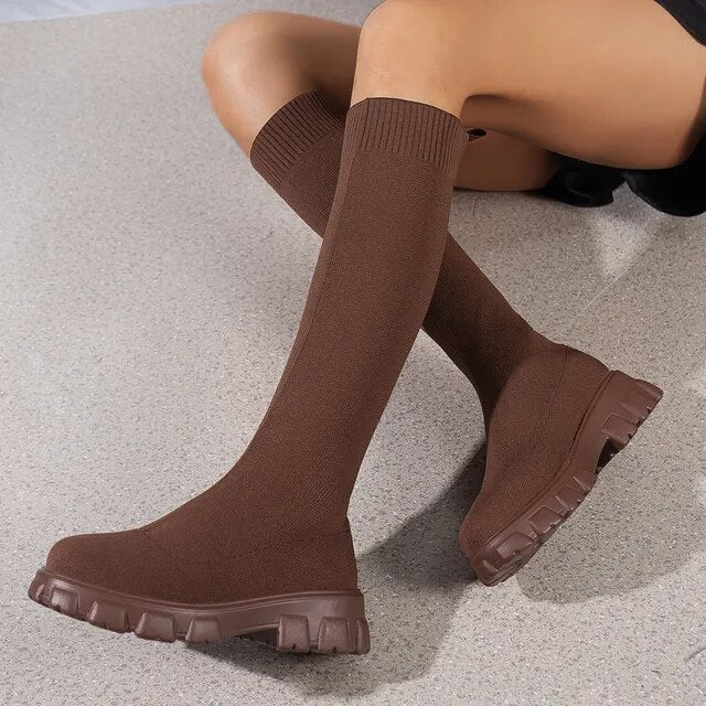 Pair of women's casual footwear: black chunky knit boots, perfect for comfort and streetwear style.