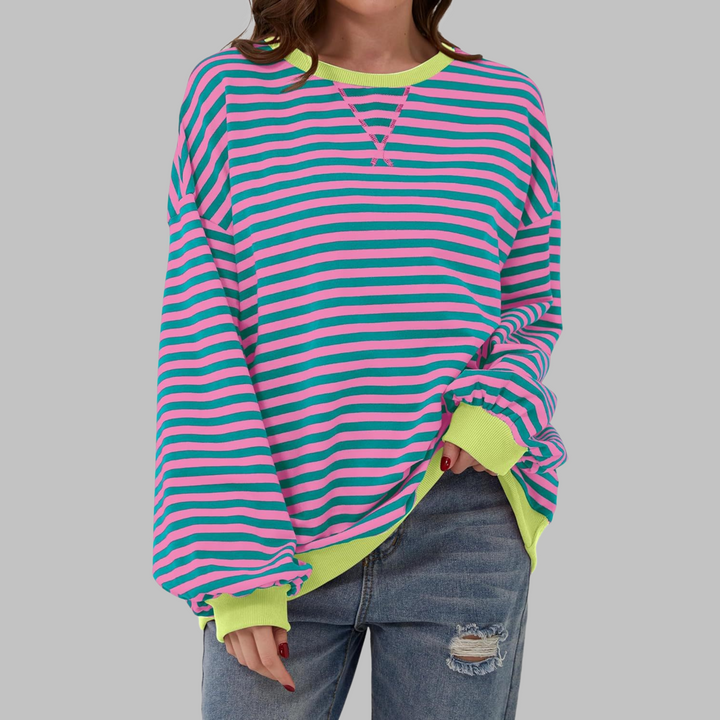 Close-up of a women's colorful striped crewneck jumper, showcasing the soft cotton blend knit texture.
