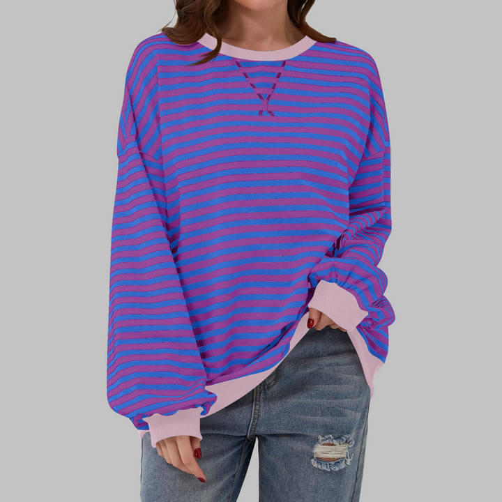 Stylish women's crewneck jumper in a colorful striped pattern, crafted from a soft cotton blend.