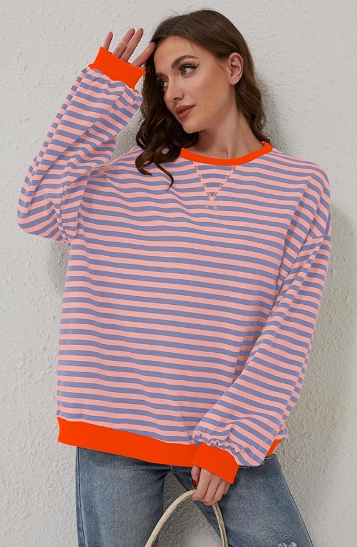 Close-up of the knit texture on a women's striped crewneck sweater, ideal for spring fashion.