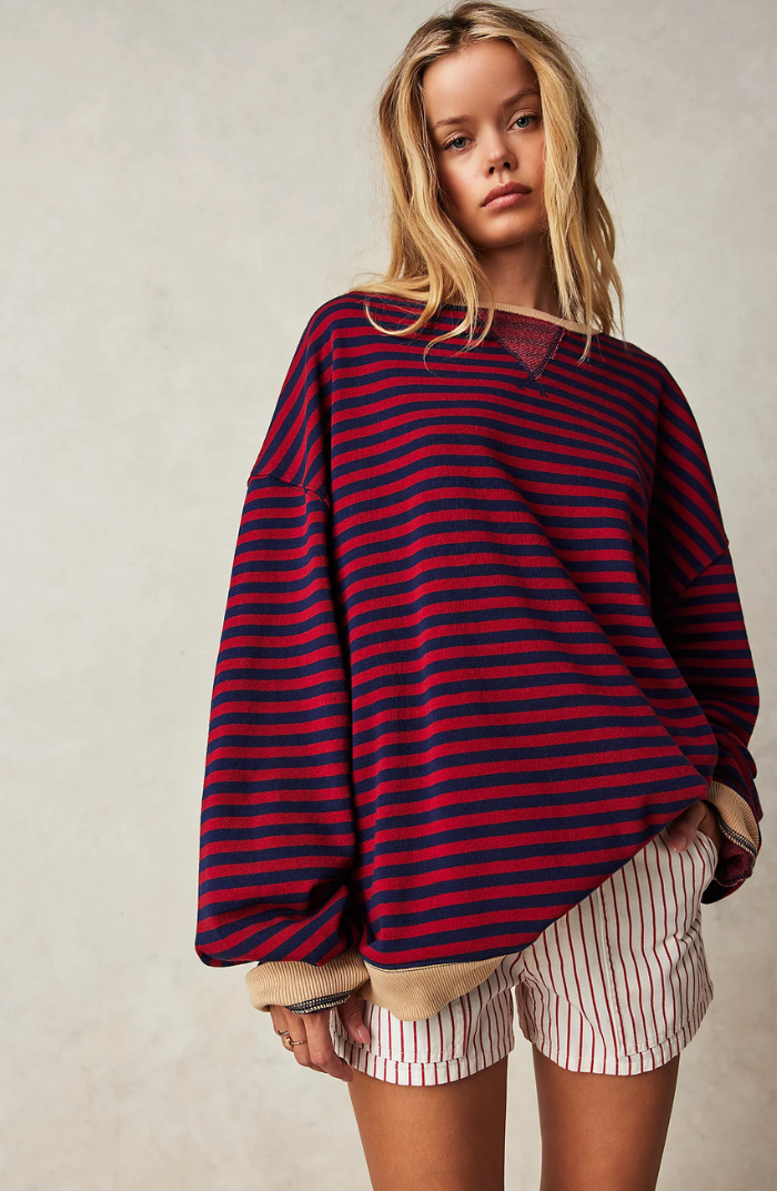 Women's striped crewneck sweater displayed flat, highlighting its classic design and soft fabric.