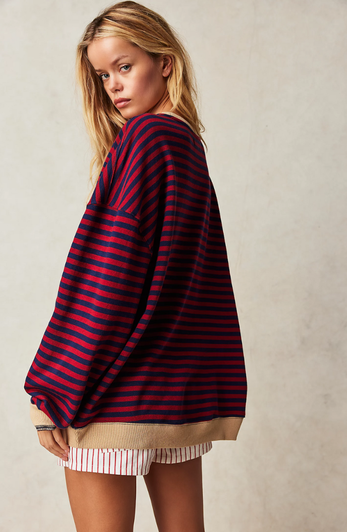 Model wearing a women's striped crewneck sweater, a comfortable and versatile top.